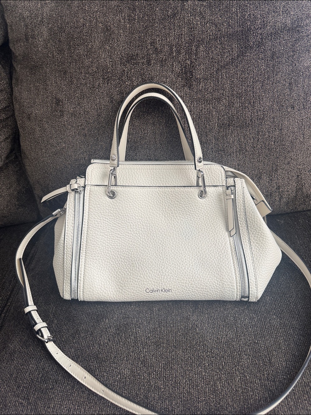 Calvin Klein cream purse with crossbody straps and handle